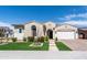 Beautiful front exterior of a home featuring a well-manicured lawn, desert landscaping, and a two-car garage at 22721 N 34Th St, Phoenix, AZ 85050