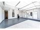 Spotless, modern garage featuring epoxy floors, storage racks, and Tesla Powerwall system at 22721 N 34Th St, Phoenix, AZ 85050