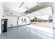 Neat garage with epoxy flooring, Tesla Powerwall setup, and well-organized storage solutions at 22721 N 34Th St, Phoenix, AZ 85050