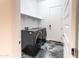 Modern laundry room featuring marbled tile floor, shelving, and updated appliances at 22721 N 34Th St, Phoenix, AZ 85050