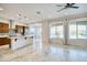 Open-concept living space with tile floors, large windows, and a view of the kitchen at 22721 N 34Th St, Phoenix, AZ 85050