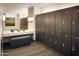 Clean locker room with dark wood lockers, seating and mirrors at 22721 N 34Th St, Phoenix, AZ 85050
