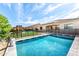 Sparkling pool with safety fence, complemented by a playground and green artificial turf under a bright sky at 22721 N 34Th St, Phoenix, AZ 85050