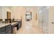 Modern bathroom featuring a double vanity with granite countertops and a glass-enclosed shower at 23109 E Nightingale Rd, Queen Creek, AZ 85142
