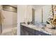 Bright bathroom with a granite countertop, glass-enclosed shower, and modern fixtures at 23109 E Nightingale Rd, Queen Creek, AZ 85142