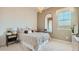 Cozy bedroom with neutral tones, a patterned bedspread, and a full-length mirror at 23109 E Nightingale Rd, Queen Creek, AZ 85142