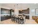 Stylish kitchen with dark wood cabinets, granite countertops, and stainless steel appliances at 23109 E Nightingale Rd, Queen Creek, AZ 85142