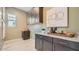 Functional laundry room with ample storage, granite countertops, and stylish cabinets at 23109 E Nightingale Rd, Queen Creek, AZ 85142