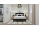 Modern bedroom with a large window, stylish lighting fixture, and neutral color palette at 23139 E Lords Way, Queen Creek, AZ 85142