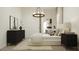 Modern bedroom with a decorative chandelier, neutral tones, and ample natural light at 23139 E Lords Way, Queen Creek, AZ 85142