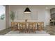 Open dining area featuring hardwood floors, modern furniture, natural light, and neutral colors at 23139 E Lords Way, Queen Creek, AZ 85142