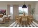 Open dining area featuring hardwood floors, modern furniture, natural light, and neutral colors at 23139 E Lords Way, Queen Creek, AZ 85142