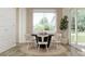 Dining room with black table, white chairs, rug, hardwood floors, and sliding glass doors at 23139 E Lords Way, Queen Creek, AZ 85142