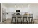 Stylish kitchen featuring a large island with seating, stainless steel appliances, and bright white cabinets at 23139 E Lords Way, Queen Creek, AZ 85142