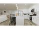 Modern kitchen with white cabinets, stainless steel appliances, and a spacious island with bar seating at 23139 E Lords Way, Queen Creek, AZ 85142