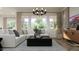 Bright living room featuring a modern chandelier and an abundance of natural light at 23139 E Lords Way, Queen Creek, AZ 85142