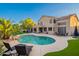A beautiful backyard featuring a refreshing pool with lounge chairs and a charming two-story home in the background at 24433 N 75Th St, Scottsdale, AZ 85255