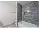 Modern bathroom featuring sleek tile, tub, shower and a tiled shower niche for toiletries at 24433 N 75Th St, Scottsdale, AZ 85255