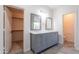 Bathroom featuring a double vanity with marble counters and walk-in closet access at 24433 N 75Th St, Scottsdale, AZ 85255
