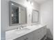 Bright bathroom featuring double sinks with marble countertops, framed mirrors, and stylish vanity lighting at 24433 N 75Th St, Scottsdale, AZ 85255