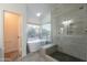 Bathroom featuring a modern tub, and glass-enclosed shower with a bench at 24433 N 75Th St, Scottsdale, AZ 85255