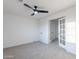 Bedroom with contemporary ceiling fan, neutral carpet, and glass paneled double doors that fill the room with light at 24433 N 75Th St, Scottsdale, AZ 85255
