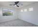 Carpeted bedroom with multiple windows for natural light and a contemporary ceiling fan fixture at 24433 N 75Th St, Scottsdale, AZ 85255
