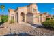 Charming two-story stucco home featuring a well-manicured desert landscape, tile roof, arched entry, and a two-car garage at 24433 N 75Th St, Scottsdale, AZ 85255