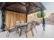 Outdoor gazebo area furnished with a table and seating for entertaining with curtains for privacy at 24433 N 75Th St, Scottsdale, AZ 85255