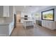 The kitchen has new white cabinets, stainless appliances, and center island; perfect for cooking and entertaining at 24433 N 75Th St, Scottsdale, AZ 85255