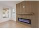 Living room featuring a modern electric fireplace, and wood-look tile flooring at 24433 N 75Th St, Scottsdale, AZ 85255