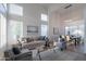 Bright living room with soaring ceilings and large windows, creating an open and airy space filled with natural light at 24433 N 75Th St, Scottsdale, AZ 85255