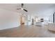 Open-concept living space with white kitchen, stainless appliances, and wood-look floors at 24433 N 75Th St, Scottsdale, AZ 85255