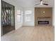 Bright living room with modern electric fireplace and sleek ceiling fan at 24433 N 75Th St, Scottsdale, AZ 85255