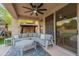 Covered outdoor patio area with plush seating, ceiling fan, and a view of the backyard at 24433 N 75Th St, Scottsdale, AZ 85255