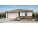 Charming single-story home featuring a two-car garage and complemented by a well-manicured front yard at 25212 N 165Th Ln, Surprise, AZ 85387