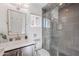 Modern bathroom featuring a glass walk-in shower, pebble accents, and a stylish vanity at 2724 W Colt Rd, Chandler, AZ 85224