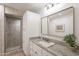 Updated bathroom with a granite countertop, modern fixtures, and a tiled shower with glass door at 2724 W Colt Rd, Chandler, AZ 85224