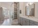 Bright bathroom with a glass-enclosed shower, gray vanity, and soaking tub with a view at 2724 W Colt Rd, Chandler, AZ 85224