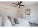 Comfortable bedroom with a ceiling fan, white dresser, and bright natural light at 2724 W Colt Rd, Chandler, AZ 85224