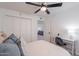 Bright bedroom featuring closet, ceiling fan, desk and opens to another living space at 2724 W Colt Rd, Chandler, AZ 85224