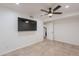 Bedroom featuring tile flooring, large wall-mounted TV, and access to a nearby doorway at 2724 W Colt Rd, Chandler, AZ 85224