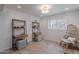 Bright bonus room with tile floors, shelving units, natural light, and comfortable seating at 2724 W Colt Rd, Chandler, AZ 85224