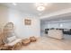 Spacious bonus room showcasing tile flooring, hanging chair, and opens to the living room at 2724 W Colt Rd, Chandler, AZ 85224