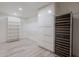 Spacious walk-in closet with custom shelving, cabinetry, and a built-in wine refrigerator at 2724 W Colt Rd, Chandler, AZ 85224
