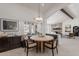 Cozy dining area with banquette seating, stylish light fixture, and backyard view at 2724 W Colt Rd, Chandler, AZ 85224