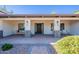 Inviting front porch with comfortable seating, decorative columns, and a beautifully landscaped garden at 2724 W Colt Rd, Chandler, AZ 85224