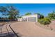 Detached garage with a paved driveway, surrounded by mature trees and manicured landscaping at 2724 W Colt Rd, Chandler, AZ 85224