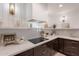 Elegant kitchen featuring sleek countertops, modern cooktop, and custom cabinetry at 2724 W Colt Rd, Chandler, AZ 85224