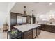 Beautiful kitchen with stainless steel refrigerator, large island, and wine storage at 2724 W Colt Rd, Chandler, AZ 85224